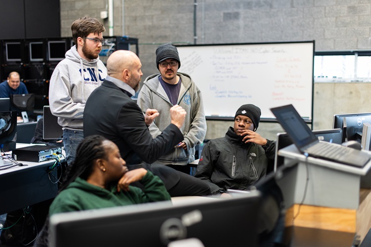 IT professor instructing students